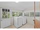 Bright laundry room with tile floors, ample windows, and modern washer and dryer at 516 Tybee Pl, Orlando, FL 32829
