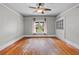 Bright living room featuring hardwood floors, ceiling fan, built in storage, and natural light at 516 Tybee Pl, Orlando, FL 32829