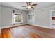 Bright living room featuring hardwood floors, ceiling fan, built in storage, and natural light at 516 Tybee Pl, Orlando, FL 32829