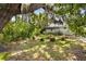 A serene property showcasing a charming home surrounded by trees, moss and green space at 516 Tybee Pl, Orlando, FL 32829