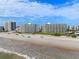 Aerial view of a sandy beach and the oceanfront condominiums along the coastline at 5201 S Atlantic Ave # 703A, New Smyrna Beach, FL 32169