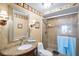 Bathroom featuring granite counters, decorative mirror and walk-in shower with a glass door at 5201 S Atlantic Ave # 703A, New Smyrna Beach, FL 32169