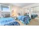 Bedroom featuring two twin beds, mirrored closet doors and natural light from the nearby window at 5201 S Atlantic Ave # 703A, New Smyrna Beach, FL 32169