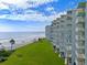 Exterior view of oceanfront condominium building with private balconies overlooking the beach at 5201 S Atlantic Ave # 703A, New Smyrna Beach, FL 32169