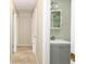 Hallway bathroom with gray vanity, white sink, and tile floors at 5300 Locksley Ave, Orlando, FL 32810