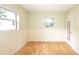 Bedroom with wood floors, beadboard walls, and windows at 5300 Locksley Ave, Orlando, FL 32810