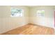 Bedroom with wood floors, and beadboard walls with natural light at 5300 Locksley Ave, Orlando, FL 32810