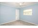 Bright bedroom with gray carpet, ceiling fan, and window at 5300 Locksley Ave, Orlando, FL 32810