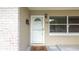 Inviting front door with brick accents, a decorative light fixture, and a patterned welcome mat at 5300 Locksley Ave, Orlando, FL 32810