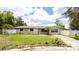 Charming single-story home featuring a well-maintained lawn, tidy landscaping, and a light beige exterior paint at 5300 Locksley Ave, Orlando, FL 32810