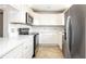 Kitchen featuring white cabinets, stainless steel appliances, and quartz countertops at 5300 Locksley Ave, Orlando, FL 32810