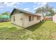 Back exterior of home with grassy lawn and privacy fence, perfect for outdoor enjoyment at 5308 Pinebury Ct, Orlando, FL 32808