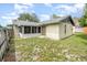The backyard of this home includes a screened in patio and lawn at 5308 Pinebury Ct, Orlando, FL 32808
