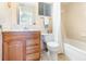 Cozy bathroom with wood vanity, marble top, framed mirror, and a shower-tub combination at 5308 Pinebury Ct, Orlando, FL 32808