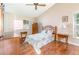 Bright bedroom featuring wood floors, ceiling fan, and natural light from the windows at 5308 Pinebury Ct, Orlando, FL 32808