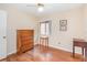 Comfortable bedroom featuring wood floors, ceiling fan, and natural light from the window at 5308 Pinebury Ct, Orlando, FL 32808