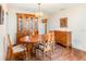 Formal dining room boasts hardwood floors, chandelier, and a large wooden hutch at 5308 Pinebury Ct, Orlando, FL 32808