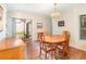 Cozy dining room area featuring warm lighting, an oval table, and sliding doors to the patio at 5308 Pinebury Ct, Orlando, FL 32808