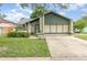Charming single Gathering home featuring a well-maintained lawn and attached two car garage at 5308 Pinebury Ct, Orlando, FL 32808