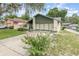 Landscaped front yard of single Gathering home with two-car garage, driveway, and blooming bush at 5308 Pinebury Ct, Orlando, FL 32808