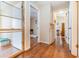 Hallway showcasing wood flooring and access to multiple rooms at 5308 Pinebury Ct, Orlando, FL 32808