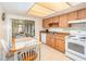 Bright kitchen featuring a breakfast nook, white appliances, and light wood cabinetry at 5308 Pinebury Ct, Orlando, FL 32808