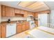 Cozy kitchen featuring light wood cabinets, white appliances, and a breakfast nook at 5308 Pinebury Ct, Orlando, FL 32808
