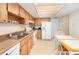 Bright kitchen with light wood cabinets, double sink, and white appliances at 5308 Pinebury Ct, Orlando, FL 32808