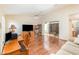 Inviting living space with hardwood flooring, desk area, and sliding glass door to outside at 5308 Pinebury Ct, Orlando, FL 32808