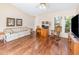 Comfortable living room with wood floors, sofa, desk, rocking chair, and bright windows at 5308 Pinebury Ct, Orlando, FL 32808