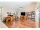 Open living room with wood floors, a ceiling fan, and sliding glass doors at 5308 Pinebury Ct, Orlando, FL 32808