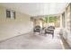 Enclosed back patio with seating and views of the backyard and home's exterior at 5308 Pinebury Ct, Orlando, FL 32808