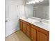 Well-lit bathroom with double sinks, ample counter space, and a large mirror at 576 Prospect Pt, Oviedo, FL 32765