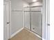 Bathroom features glass enclosed shower and neutral tile flooring at 576 Prospect Pt, Oviedo, FL 32765