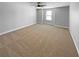 Neutral bedroom with plush carpet, a large window, and ample natural light at 576 Prospect Pt, Oviedo, FL 32765