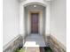 Covered entryway featuring a dark wood door framed by brick accents and white trim at 576 Prospect Pt, Oviedo, FL 32765