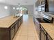 Modern kitchen with island sink, stainless steel appliances, and sliding door access to backyard at 576 Prospect Pt, Oviedo, FL 32765