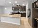 Modern kitchen with granite countertops, dark cabinetry, and stainless steel appliances at 576 Prospect Pt, Oviedo, FL 32765