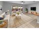 Bright living room with neutral tones, modern furnishings, and sliding glass doors to outdoor area at 576 Prospect Pt, Oviedo, FL 32765