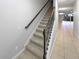 Carpeted stairs with decorative wood and metal railing leading to upstairs living areas at 576 Prospect Pt, Oviedo, FL 32765