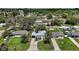 Birds eye view of the property with a double-wide driveway in a lush green neighborhood at 716 N Rockingham Ave, Tavares, FL 32778