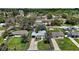 Aerial view of house showing the entire property, surrounding landscape, and a double-wide driveway at 716 N Rockingham Ave, Tavares, FL 32778