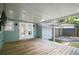 Cozy covered back porch featuring a wood floor, white ceiling, and ceiling fan at 716 N Rockingham Ave, Tavares, FL 32778