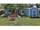 Landscaped backyard featuring a hot tub under a pergola, a brick fire pit, and a storage shed at 716 N Rockingham Ave, Tavares, FL 32778