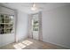 Neutral bedroom with light from windows and a ceiling fan at 716 N Rockingham Ave, Tavares, FL 32778