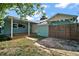 Charming home exterior with a covered porch, wooden fence and gated access at 716 N Rockingham Ave, Tavares, FL 32778
