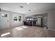 Open floor plan with light wood floors connecting the living area to the updated kitchen at 716 N Rockingham Ave, Tavares, FL 32778