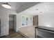 Bright living room with wood floors, white trim, and french doors leading to the exterior at 716 N Rockingham Ave, Tavares, FL 32778
