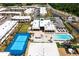 Aerial view showcases a modern complex with a pool, clubhouse, and recreational areas at 7478 Brooklyn Dr, Kissimmee, FL 34747