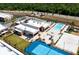 Aerial view showcasing a large community pool, tennis court, sand volleyball, and recreational amenities at 7478 Brooklyn Dr, Kissimmee, FL 34747